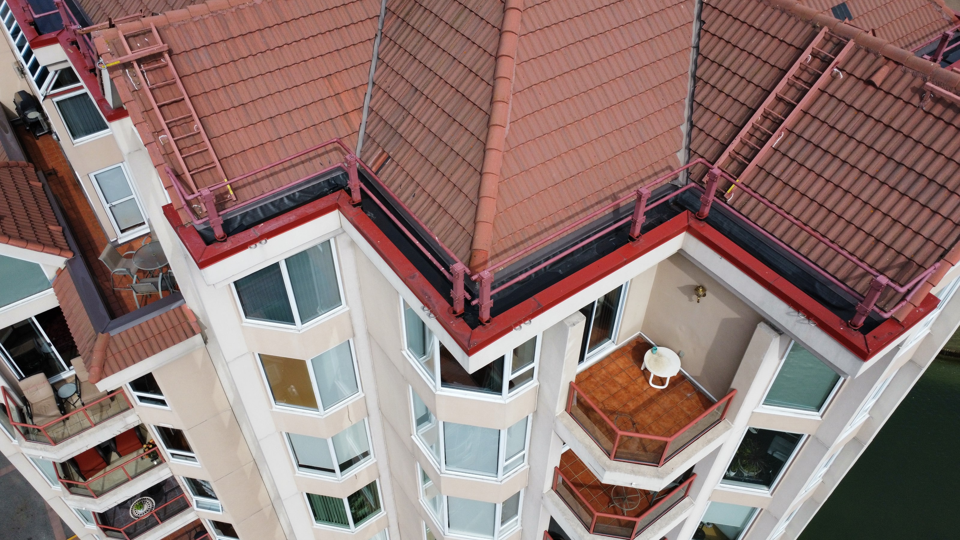 The new EPDM gutters running behind the tile roof at the top of the tower