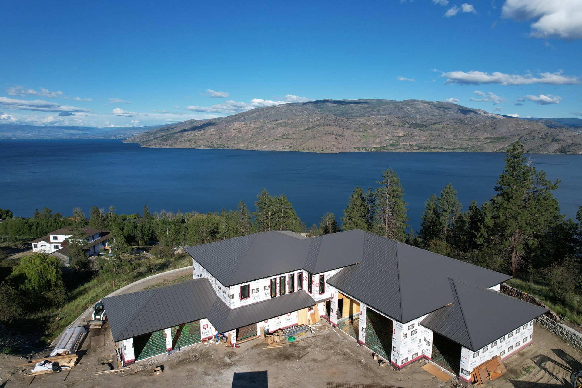 The new home and its charcoal metal roof above Okanagan Lake