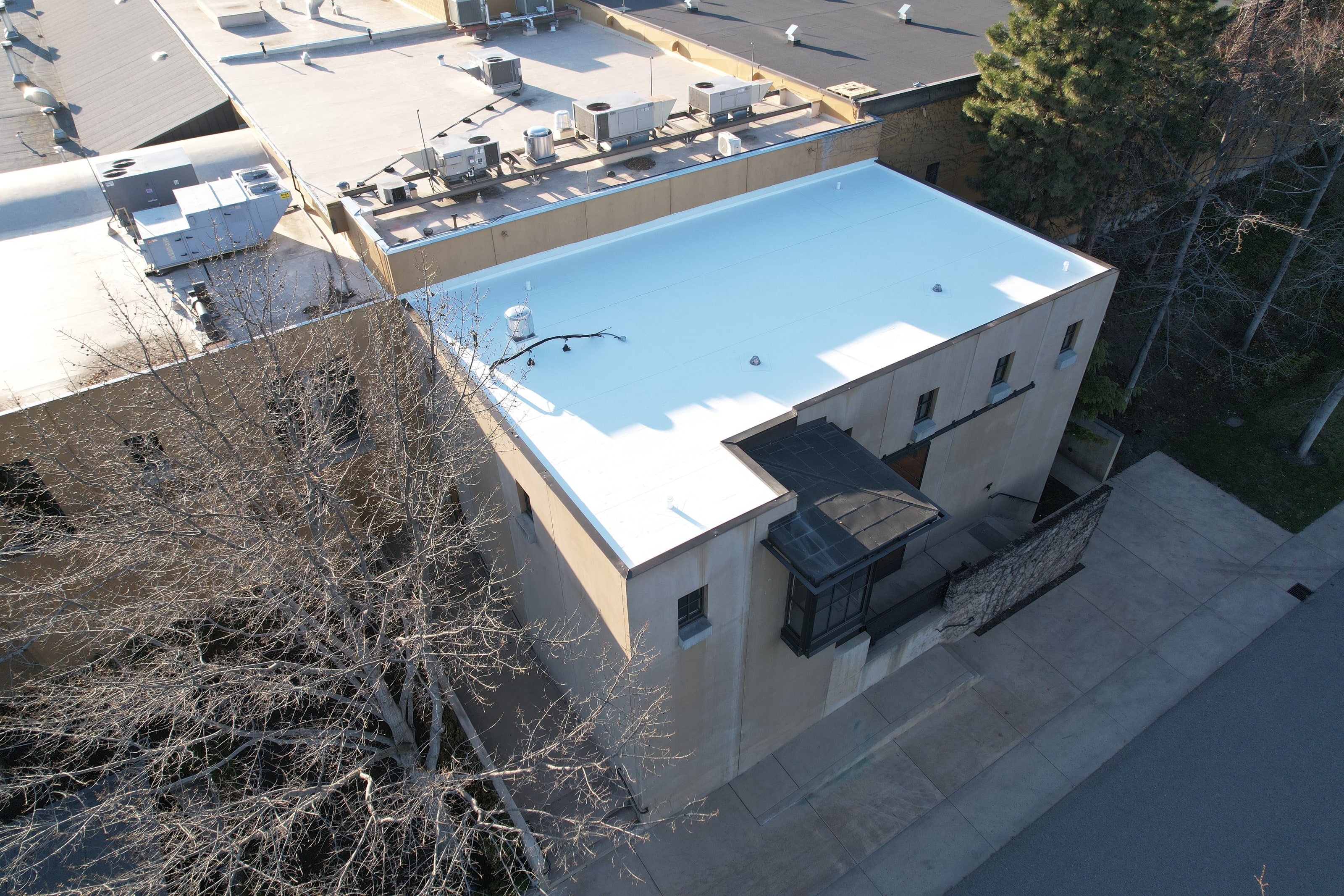 The winery building from above: the white TPO roof and the new parapet metal around it