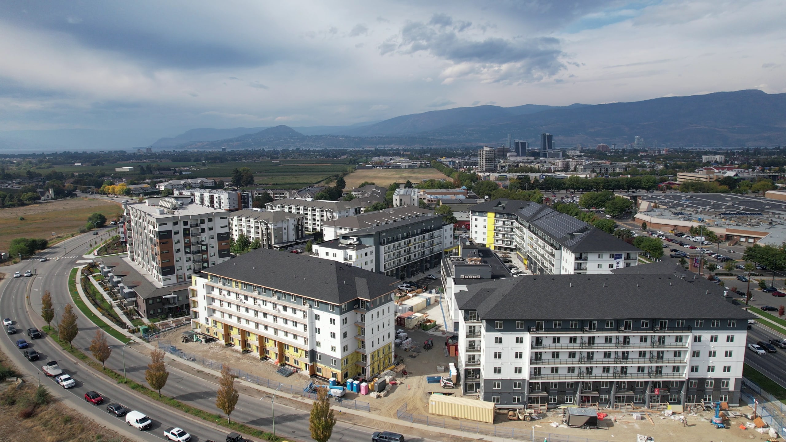 New multi-unit residential buildings seen from the air, the city and the hills beyond