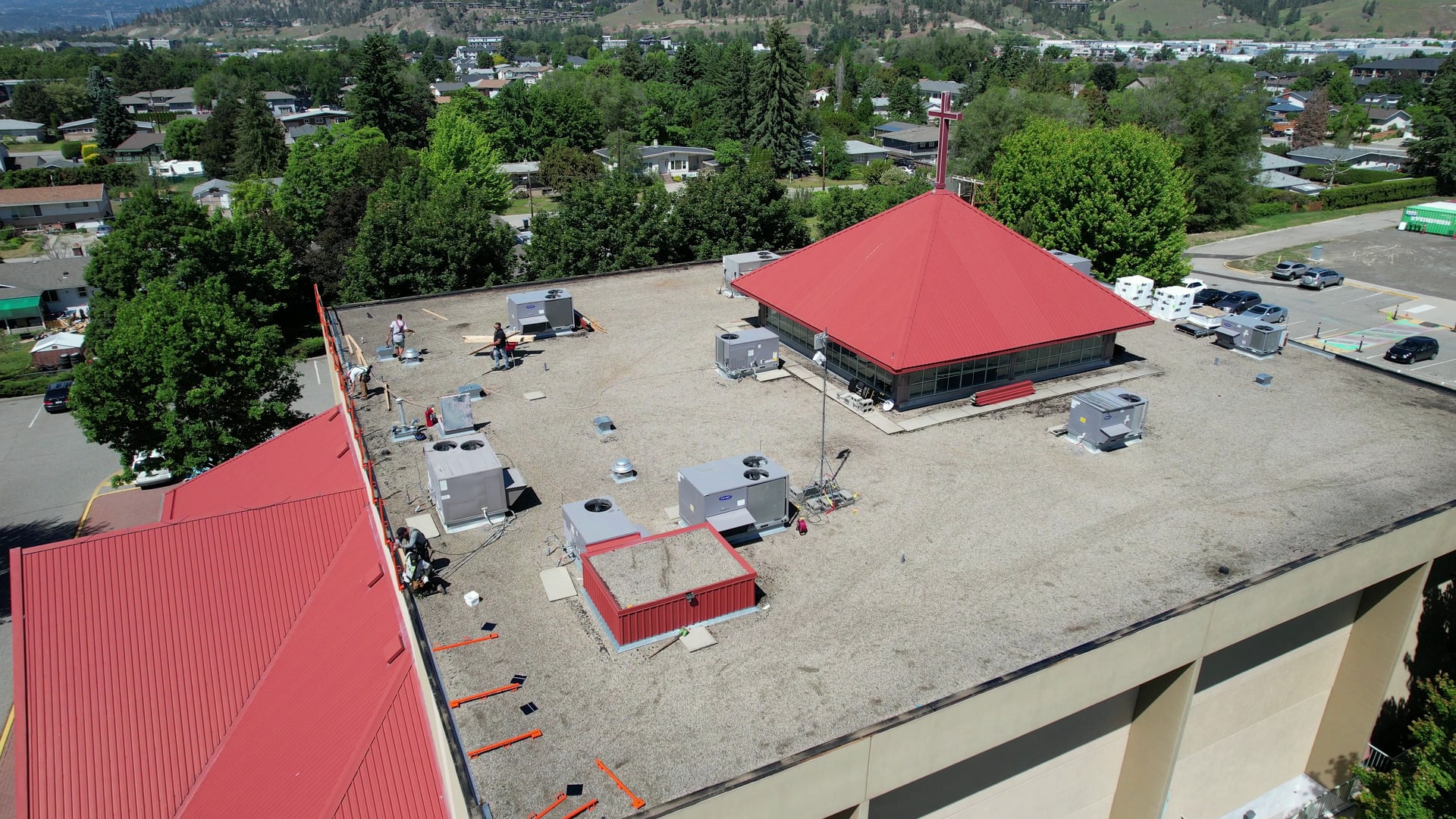 A church flat roof, old tar and gravel, then the same roof finished in torch-on