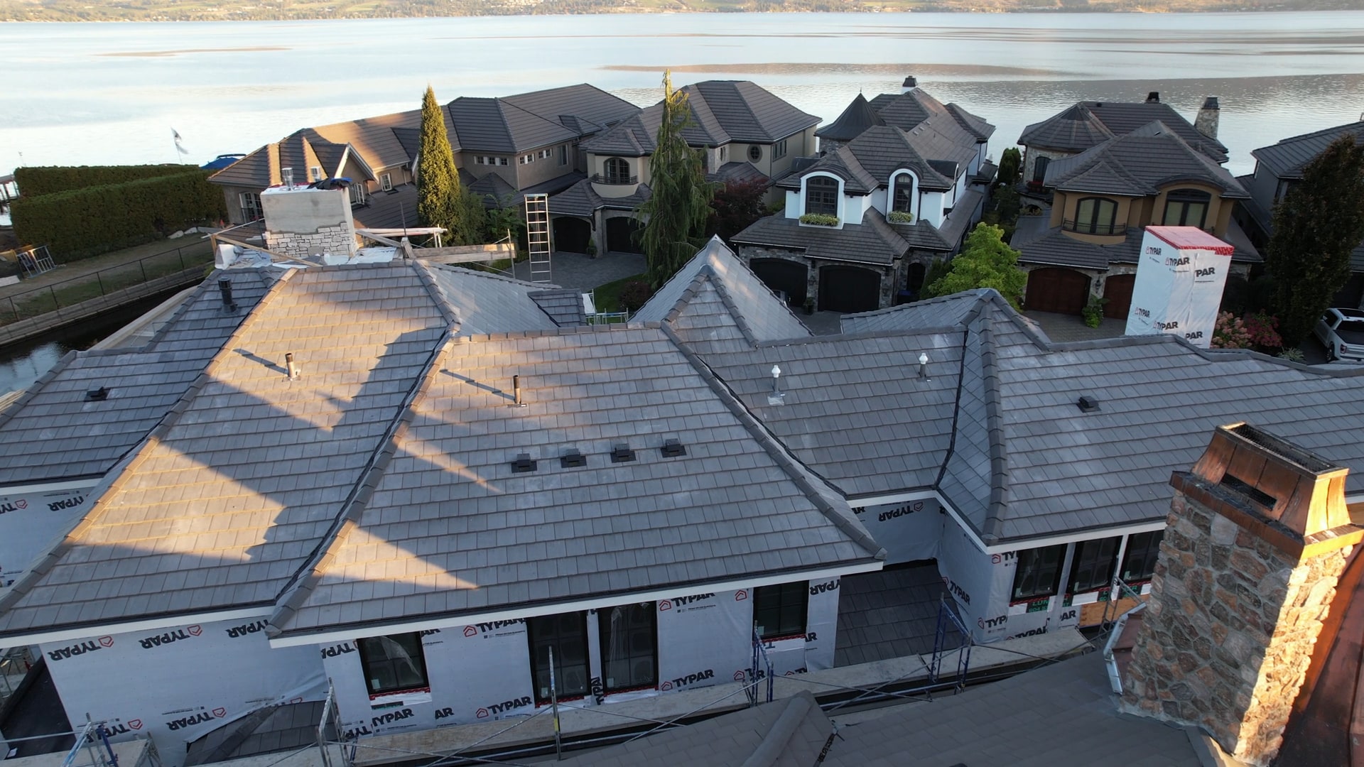 Concrete tile roof on a lakefront home, seen from the air