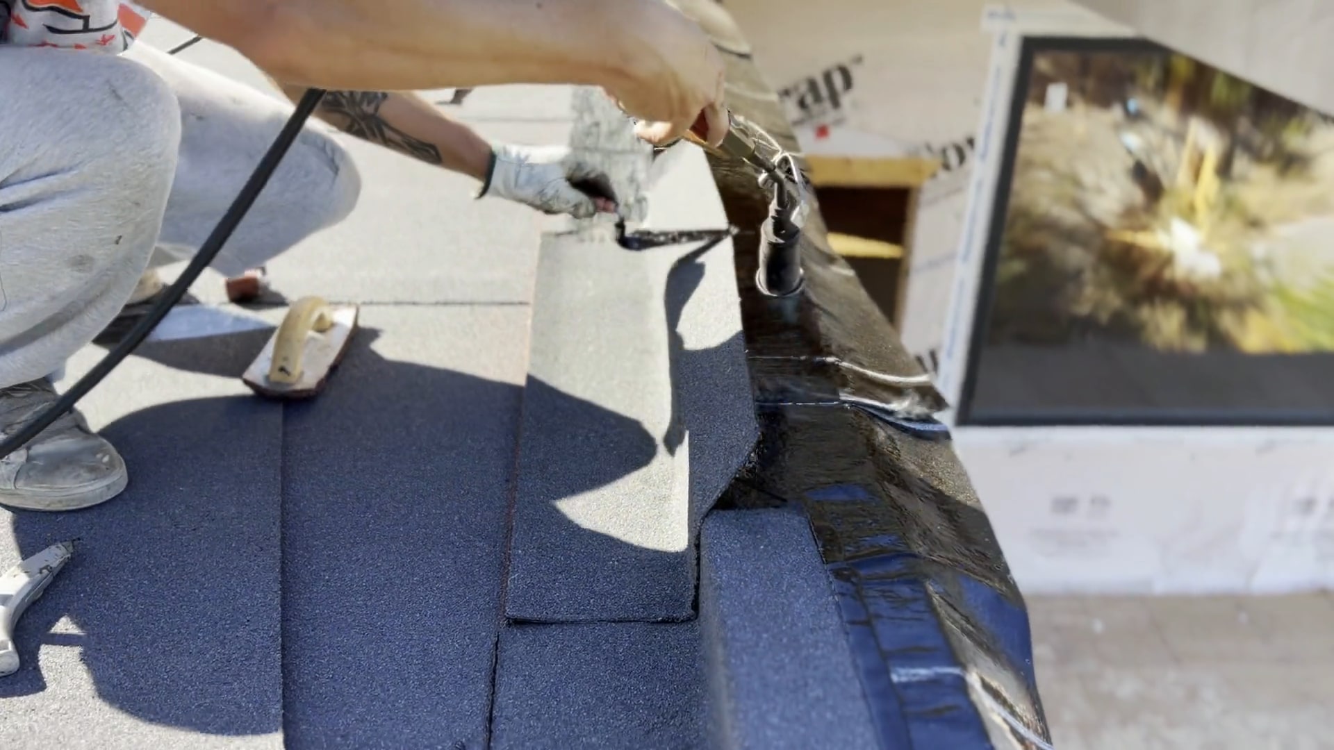 Close-up of a roofer torching a torch-on flashing detail